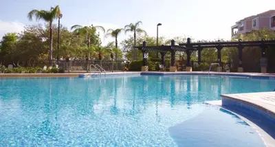 a large blue swimming pool with a gazebo at Vista Cay Luxury Secret condo in Orlando