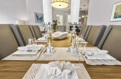 a dining table with glasses and napkins on it at Vista Cay Luxury Secret condo in Orlando