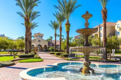 a fountain in a courtyard with palm trees at Lake View 3 Bedroom In Vista Cay Resort condo in Orlando