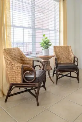 two chairs and a table in a room with a window at Pool View Penthouse condo in Orlando