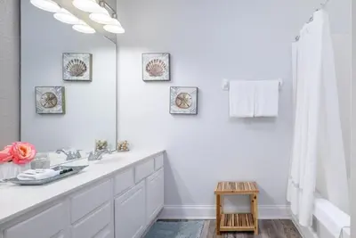 a white bathroom with a sink and a mirror at Vista Cay Casa Bella townhouse in Orlando