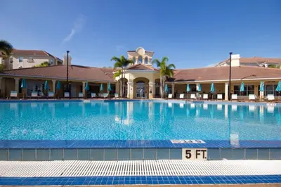 a large swimming pool in front of a building at Vista Cay Casa Bella townhouse in Orlando
