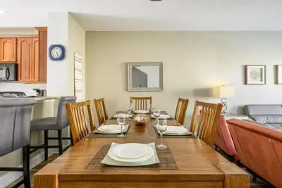 a dining room with a table with wine glasses at Vista Cay Casa Bella townhouse in Orlando