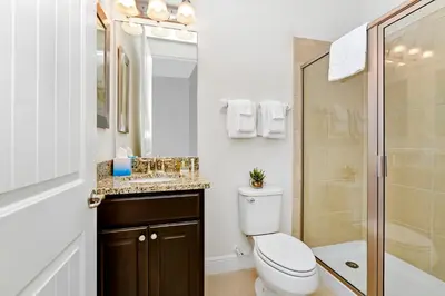 a bathroom with a toilet and a sink and a shower at Enchanting Home Near Disney With Game And Themed Rooms With Waterpark & Resort Access At Encore Resorts Reunion - 7403Mr in Kissimmee
