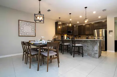 a kitchen and dining room with a table and chairs at Stunning 3Bd Close to Disney at Fiesta Key 4764 in Kissimmee