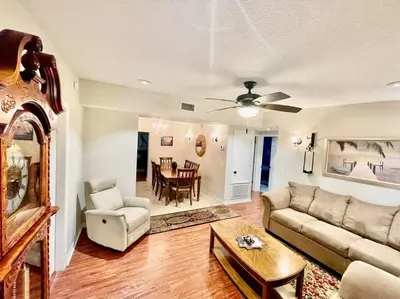 a living room with a couch and a table at Cozy Modest Home near Universal Studios/VolcanoBay in Orlando