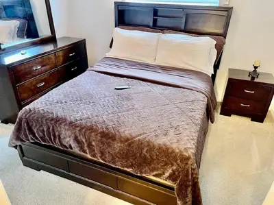 a bedroom with a bed with a mirror and a dresser at Cozy Modest Home near Universal Studios/VolcanoBay in Orlando