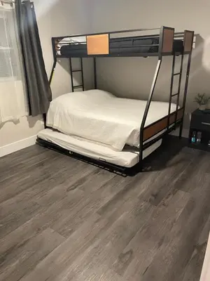 a bedroom with a bunk bed and a wooden floor at Clear Lake Retreat: Private pool, lakefront in Orlando