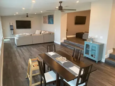 a dining room and living room with a table and a couch at Clear Lake Retreat: Private pool, lakefront in Orlando