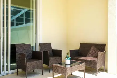 a group of chairs and a table on a patio at Marvelous 3Bd w Pool Near Disney at Serenity 1536 in Orlando