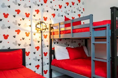 a bedroom with two bunk beds and a wall with hearts at Marvelous 3Bd w Pool Near Disney at Serenity 1536 in Orlando