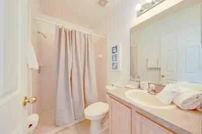 a bathroom with a sink and a toilet and a shower at 606 - Stunning 5 bed vacation rental home with private pool in Kissimmee