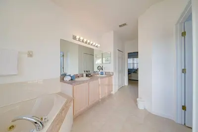 a large bathroom with two sinks and a tub at 606 - Stunning 5 bed vacation rental home with private pool in Kissimmee