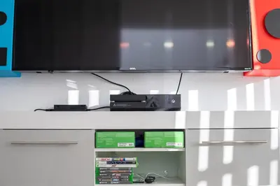 a flat screen tv sitting on top of a cabinet at 606 - Stunning 5 bed vacation rental home with private pool in Kissimmee