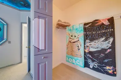 a room with a poster of a cat on the wall at 606 - Stunning 5 bed vacation rental home with private pool in Kissimmee