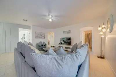 a living room with a couch and a tv at 606 - Stunning 5 bed vacation rental home with private pool in Kissimmee