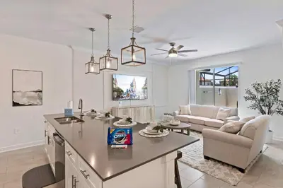 a kitchen and living room with a table and a couch at 4423 Scene Lane in Kissimmee