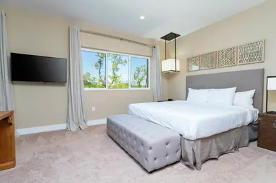 a bedroom with a large bed and a large window at Magical 4suites Home w jacuzzi near Disney 7497 in Orlando