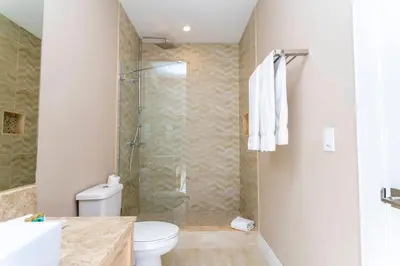 a bathroom with a shower and a toilet at Magical 4suites Home w jacuzzi near Disney 7497 in Orlando