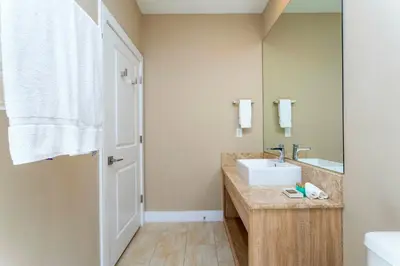 a bathroom with a sink and a mirror at Magical 4suites Home w jacuzzi near Disney 7497 in Orlando