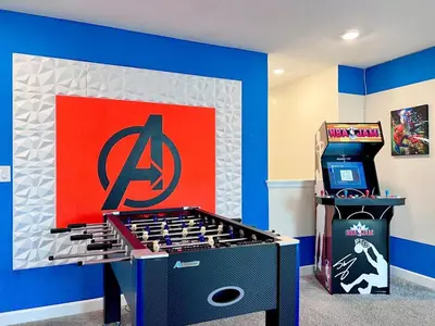 a game room with a video game machine and a sign at Spacious Home with Fun Decore and Game Room-4544TB in Kissimmee