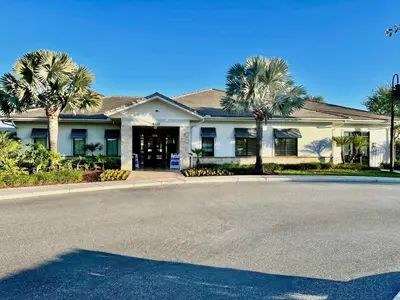 a house with palm trees in front of a street at Spacious Home with Fun Decore and Game Room-4544TB in Kissimmee