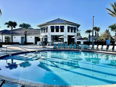a large swimming pool in front of a house at Spacious Home with Fun Decore and Game Room-4544TB in Kissimmee