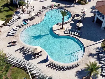 an overhead view of a large swimming pool with lounge chairs and sidx sidx at Spacious Home with Fun Decore and Game Room-4544TB in Kissimmee