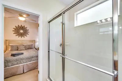 a glass door leading to a bedroom with a bed at 10 Mi to Disney Home with Game Room and Lanai! in Kissimmee