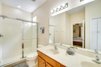 a bathroom with a sink and a shower and a toilet at 10 Mi to Disney Home with Game Room and Lanai! in Kissimmee