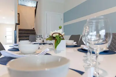 a table with plates and glasses on a table at 820DSD - The Retreat at ChampionsGate home in Orlando