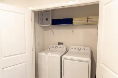 a laundry room with a washer and dryer at 820DSD - The Retreat at ChampionsGate home in Orlando