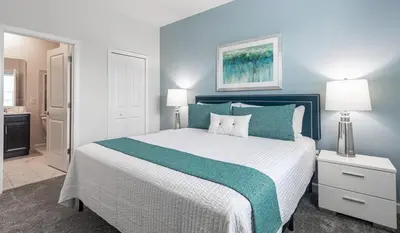 a bedroom with a large bed with blue walls at 820DSD - The Retreat at ChampionsGate home in Orlando