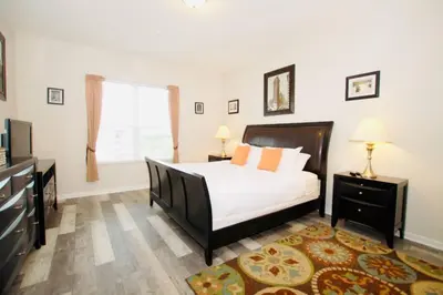 a bedroom with a bed and a large window at Vista Cay Luxury Loft in Orlando