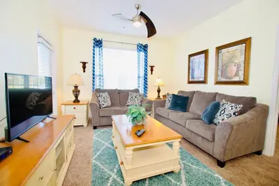 a living room with a couch and a tv at Vista Cay - Cosy 3 bedroom condo in Orlando