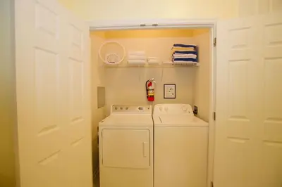 a small laundry room with a washer and dryer at Vista Cay - Cosy 3 bedroom condo in Orlando