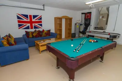a living room with a pool table in it at Emerald Escape - New Pool Home in Kissimmee