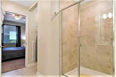a bathroom with a shower with a glass door at Cozy Condo Only 6 Minutes From Disney World in Kissimmee