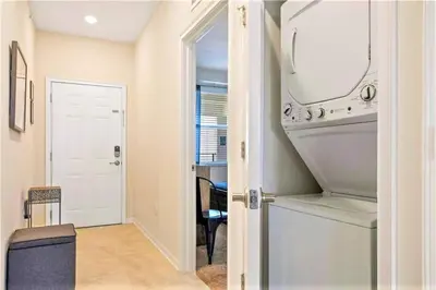 a laundry room with a washer and dryer at Cozy Condo Only 6 Minutes From Disney World in Kissimmee