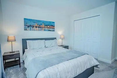a bedroom with a large bed and two night stands at Relax in Ultimate Comfort with Pool & BBQ Area in Kissimmee