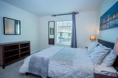 a bedroom with a large bed and a window at Relax in Ultimate Comfort with Pool & BBQ Area in Kissimmee
