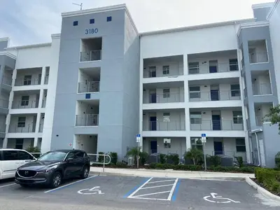 a car parked in a parking lot in front of a building at Exquisite First-Floor Condo, 7 Min to Disney in Kissimmee