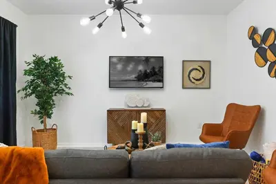a living room with a couch and a chair at Exquisite First-Floor Condo, 7 Min to Disney in Kissimmee