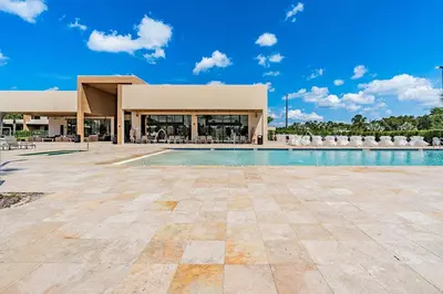 a swimming pool in front of a building at Sophisticated 4 En Suites w Private Hot Tub & BB in Orlando