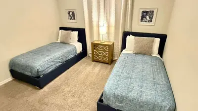 a bedroom with two beds and a night stand at Charming Holiday Condo, Only 7 min to Disney in Kissimmee