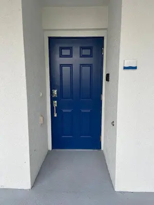 a blue door in a hallway of a building at Charming Holiday Condo, Only 7 min to Disney in Kissimmee