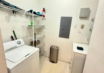 a white bathroom with a sink and a washing machine at 2BR2BA Getaway 7 Miles from Orlando Parks in Kissimmee