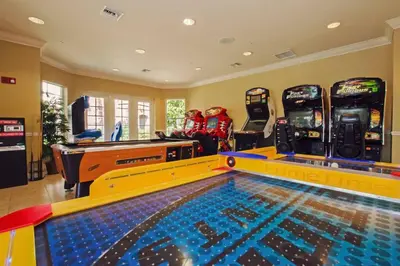 a game room with a pool and ping pong tables at Vista Cay Luxury 3BR Condo in Orlando
