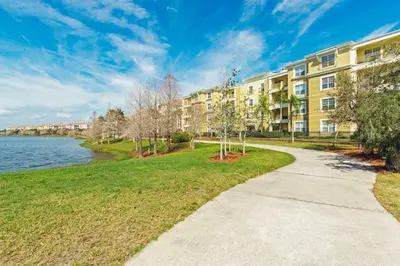 a walkway in front of a building with a body of water at Vista Cay Luxury 3BR Condo in Orlando