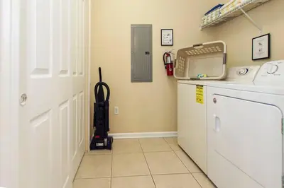 a kitchen with a washer and dryer in a room at Luxury Lake View Condo-Vista Cay in Orlando